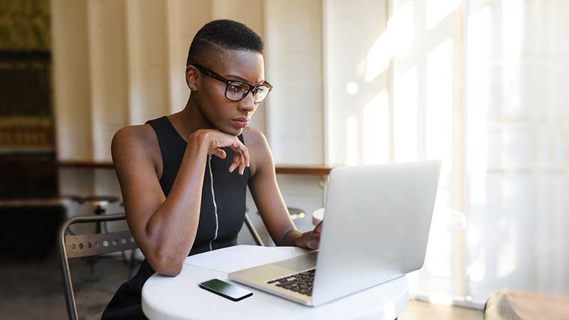 Woman working on a laptop at a table